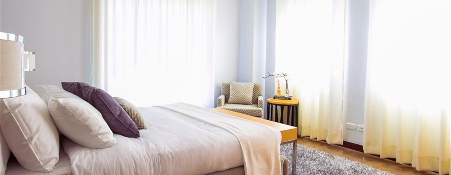 A bright, freshly cleaned bedroom in an Orange County home